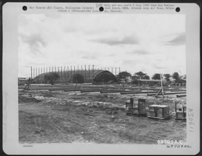 Consolidated > A Luria Catenary portable combat canvas-covered hangar is assembled on Neilson Field, Luzon, Philippine Islands, 31 May 1945. If these hangars are erected on the production line basis, it takes approximately three days. If one is built individually
