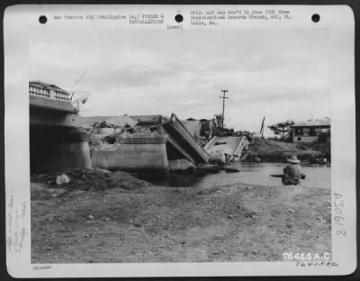 Consolidated > Bomb damaged Meycaugan bridge somewhere in the Philippine Islands being reconstructed by "B" Co., 1876th Eng. Aviation Battalion. 10 February 1945.