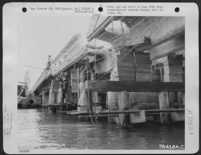 Consolidated > Men of the 1876th Eng. Aviation Battalion at work repairing a bomb damaged bridge somewhere in the Philippine Islands. 25 June 1945.