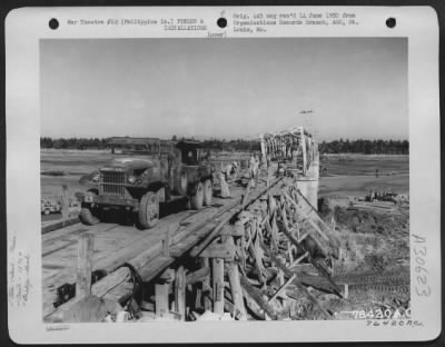 Consolidated > Members of the 1876th Eng. Aviation Battalion repair a bomb damaged bridge somewhere in the Philippine Islands. 6 May 1945.