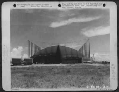 Consolidated > This portable combat canvas-covered hangar is being used as a warehouse for Air Corps supplies at Depot #7, Nielson Field, Manila, Philippine Islands. 31 May 1945.