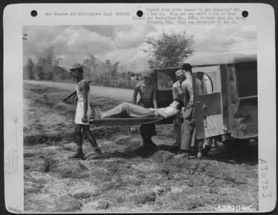 Consolidated > Nielson Field, Manila, 11 May 1945. Co. "C," 264th Medical Bn.-Unloading patient at receiving tent of the Holding Company. This patient was evacuated from a forward area by air in a Vultee L-5.