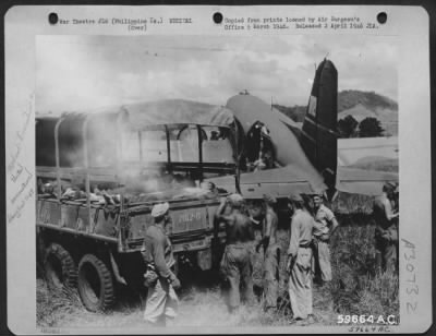 Consolidated > Mindanao, Philippine Islands, 8 May 1945. Troops of the 124th Infantry Regiment being evacuated from Valencia Airstrip. Troop carrier planes after completing the last trip of their shuttle runs, picked up any wounded personnel to be evacuated and