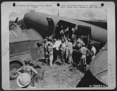 Consolidated > Mindanao, Philippine Islands, 12 May 1945. Evacuation of patients by air from Valencia airstrip in C-47's which flew them to base hospital at Malabang. The C-47's flew rations in and patients out.