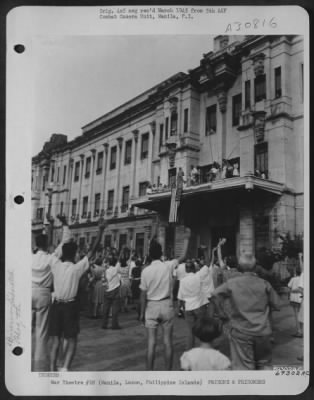 Thumbnail for Consolidated > The first American flag to be raised at Santo Tomas Prison in over three years goes up to the roars of the assembled civilian prisoners. Flags were brought in by our troops, but smaller flags and bunting was hidden by the inmates in the University