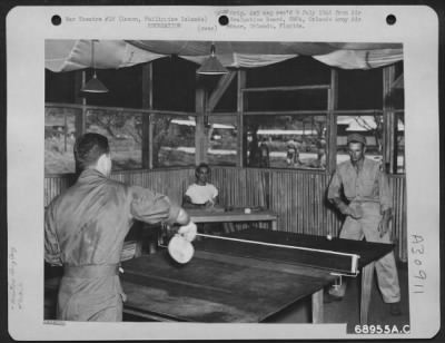 Consolidated > A lively game of ping pong-one of the favorite diversions-keeps these men on their toes. The 11th Special Services equipped the squadrons' day rooms on Clark Field, Luzon, Philippine Islands, with ping pong tables as well as the usual reading and