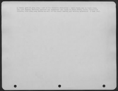 Consolidated > A lively game of ping pong-one of the favorite diversions-keeps these men on their toes. The 11th Special Services equipped the squadrons' day rooms on Clark Field, Luzon, Philippine Islands, with ping pong tables as well as the usual reading and