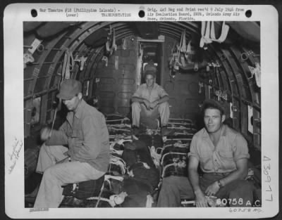 Consolidated > C-47 "Skytrain" loaded with .81mm mortar shells, en-route to target at Itogan, Luzon, Philippine Islands. On similar missions as this, medical supplies, clothing, food, oil, gas ammunition,  guns and barbed wire are dropped to troops and guerillas in