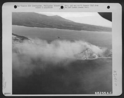 Consolidated > Douglas C-47 just completing paratroop dropping pass and entering pattern for the next drop. Smoke is from the naval shelling of the San Jose area, where amphibious landing was made. 1944.