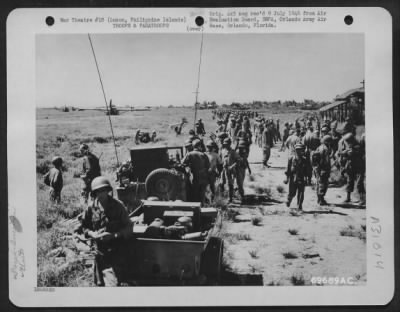 Consolidated > Men of the 11th Airborne Division assemble at a pre-destined point shortly after their parachute landing at Appari Airstrip in Northern Luzon, Philippine Islands. The aerial armada consisted of troop carrier planes and gliders carrying field pieces