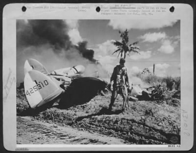 Consolidated > MIRACULOUS ESCAPE--A dramatic picture of Lt. S.F. Ford, fighter-pilot from Baltimore, Maryland, walking from his Lockheed P-38 Lightning unharmed a few seconds after he crash landed. He was shot down in flames by a Jap Zero over Mindoro Island