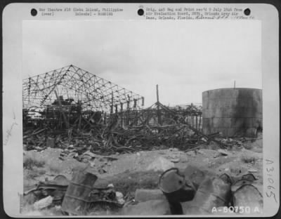 Consolidated > Intense heat left this heap of twisted steel at the Madrigal Oil Refinery, Cebu City. Fire raged through the refinery as a result of Allied air attacks.
