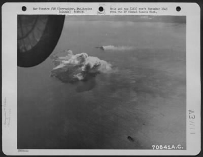 Consolidated > Bombs, dropped from Consolidated B-24 "Liberators" of the 494th Bomb Group, burst on their targets-Corregidor and Caballo Island in the Philippines. 14 February 1945.