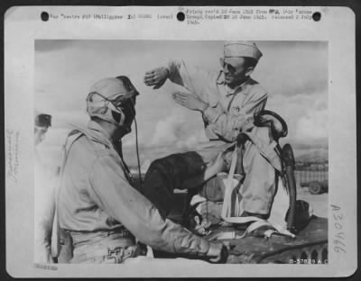 Consolidated > Capt. Pable Rivas M., Of Mexico, D.F., (Extreme Right) Illustrates With His Hands A Part Of The Mexican Expeditionary A.F.'S First Combat Mission To Capt. Roberto Legorreta S. Of Jocotitan, Mexico.  The Two Pilots Have Just Landed After Having Bombed The