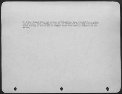 Consolidated > Mr. & Mrs. Michael O'Hara And Children Of Philadelphia, Pa., Liberated From A Prison Camp At Manila, Luzon, Philippine Islands, Are Interviewed By An Army Representative Before Boarding An Amtrack For New Bilibid Prison Where They Will Receive Food And Sh