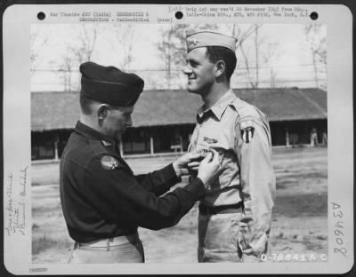 Consolidated > An Officer Presents The Distinguished Flying Cross To A Member Of The 1330Th Aaf Base Unit, Air Transport Command, During A Ceremony At An Airbase At Jorhat, Assam, India. 20 March 1945.