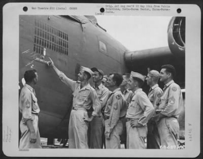 Thumbnail for Consolidated > Crew Members Of The Consolidated B-24 "Sittin' Bull" Look Proudly At The Markings On The Side Of Their Plane.  India.