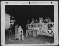 At an air base near Bengasi, Cirenaica, Libya, crew members of a Ninth U.S. Air Force Consolidated B-24 "Liberator" bomber arrive at their plane just before taking off on the historic bombing raid on the Ploesti, Roumania oil fields and refineries. - Page 3