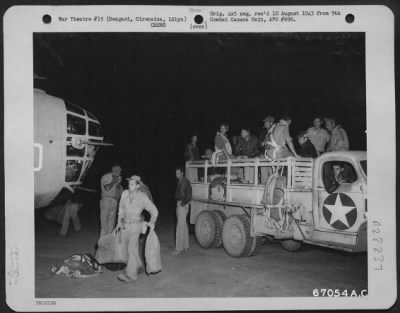 Consolidated > At an air base near Bengasi, Cirenaica, Libya, crew members of a Ninth U.S. Air Force Consolidated B-24 "Liberator" bomber arrive at their plane just before taking off on the historic bombing raid on the Ploesti, Roumania oil fields and refineries.