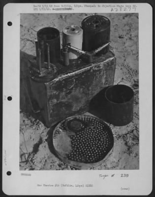 Thumbnail for Consolidated > A dismantled "S" mine on an airfield near Nufilis. The tray in front of the parts contains metal balls which are scattered with deadly effect when the mine is exploded.