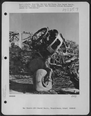 Thumbnail for Consolidated > Wrecked landing gear still standing in the wreckage of an enemy aircraft on the landing ground at Castel Benito airfield near Tripoli, Tripolitania, Libya. 26 January 1943.