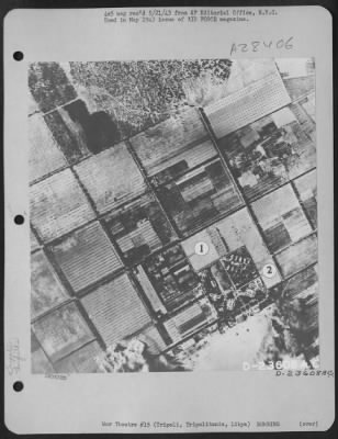 Thumbnail for Consolidated > Vast destruction is left behind at the Nazi airdrome at Tripoli, Tripolitania, Libya. The shops and assembly sheds (1) and barracks (2) are shown directly below the departing bombers.