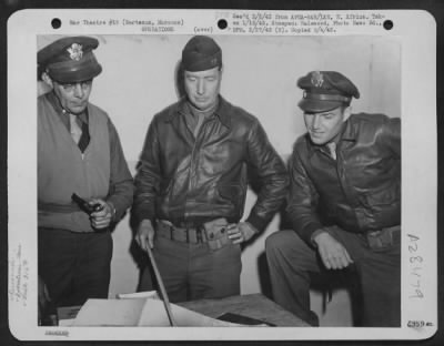 Consolidated > Berteaux, Morocco-Air Corps Intelligence Officers of the 316th Bomber Unit during a discussionon enemy ack ack gun positions. (L to R) Lt. Rupert A. Nock, Newburyport, Mass., Capt. W.G. Gridley, Locust, New Jersey and Lt. Edward P. Meehan, Hamiliton