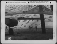 A camouflage net over a North American B-25 at an airdrome in North Africa. 18 February 1943. - Page 1