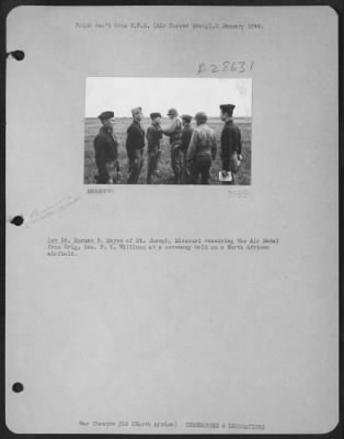 Thumbnail for Consolidated > 1st Lt. Norman B. Mayse of St. Joseph, Missouri receiving the Air Medal from Brig. Gen. P.L. Williams at a ceremony held on a North African airfield.