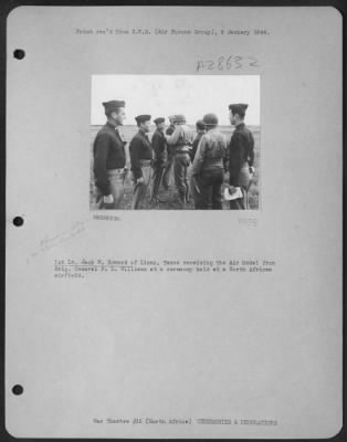 Thumbnail for Consolidated > 1st Lt. Jack W. Howard of Llano, Texas receiving the Air Medal from Brig. General P.L. Williams at a ceremony held at a North African airfield.