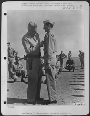 Thumbnail for Consolidated > 1st Lt. Ernest M. Duckworth, Cranston, R.I., receiving the Silver Star for gallantry in action. While acting as Navigator-Bombardier of a B-24D making an attack on Benghazi, a faulty bomb release made it necessary to take three runs over the target