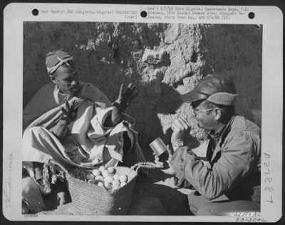 Thumbnail for Consolidated > Algiers, Algeria-Men trading Arab can of rations for eggs.