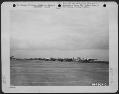 Consolidated > Transient aircraft-North American B-25s and Douglas C-47s-are lined up on Nichols Field, Luzon, Philippine Islands, prior to movement to Japan. 20 August 1945.