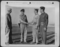 Lt. Col. Harvey H. Hinman, Denver, Colo., and Col. Anthony G. Hunter, Kansas City, Mo., Group Commander, congratulate 1st Lt. Randolph M. Duncan, Caldwell, N.J., armament officer, and S/Sgt. Loy G. Myers, Hume, Ohio, upper-turret gunner, on receiving - Page 1