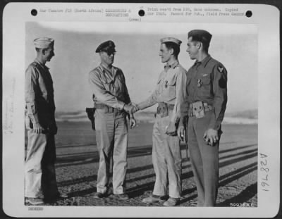 Consolidated > Lt. Col. Harvey H. Hinman, Denver, Colo., and Col. Anthony G. Hunter, Kansas City, Mo., Group Commander, congratulate 1st Lt. Randolph M. Duncan, Caldwell, N.J., armament officer, and S/Sgt. Loy G. Myers, Hume, Ohio, upper-turret gunner, on receiving