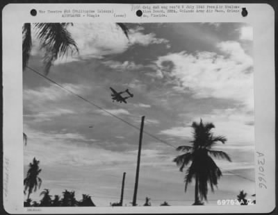 Consolidated > A Lockheed P-38 "Lightning" buzzing a base somewhere in the Philippines Islands.