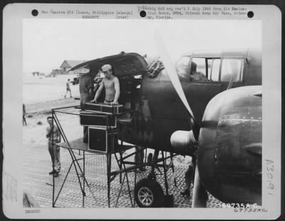 Thumbnail for Consolidated > Five minutes after the plane had landed at Clark Field, Luzon, Philippine Islands, armorers were busy re-locating the guns on this North American B-25 of the 823rd Bomb Squadron, 38th Bomb Group. 17 May 1945.