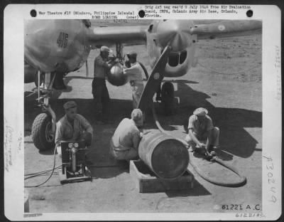 Consolidated > Immediately after mixing the Napalm solution, the filled drums are taken by truck to the waiting plane. Three 55 gallon drums are required to fill each tank and there are two tanks to a fighter-bomber. 894th Chemical Company, 3rd Bomb Group. Elmore