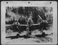 Head-on view of Jap fighter-bomber muzzle of cannon and three-bladed props. Palawan Island, P.I. - Page 1