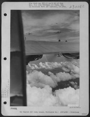 Consolidated > A Large Formation Of Consolidated B-24 Liberators Of The 866Th And 867Th Bomb Squadrons, 494Th Bomb Group, Enroute To Bomb Enemy Installations On Cebu Island In The Philippine Islands, Fly High Over Fleecy Clouds. 6 December 1944.