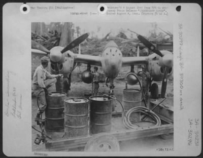 Consolidated > Incendiary Bombs (#1 Of Two Pictures)  Twin Belly Tanks Of This P-38 Lightning  Of The 13Th Aaf Fighter Command Based In The Philippines Are Filled With Napalm Gel Transferred From The Drums By Air Pressure.  These Tanks Will Be Jettisoned Over Japanese T