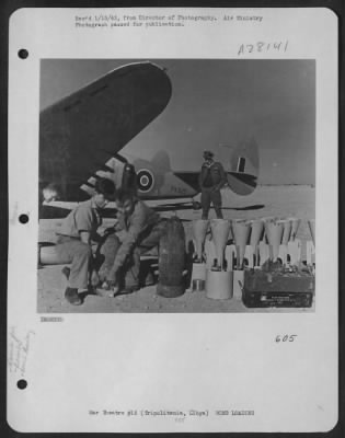 Thumbnail for Consolidated > Air transport squadrons which kept the ground forces supplied with ammunition, food and fuel in the advance through Libya are now keeping the advanced striking force of the Allied Air Forces supplied with bombs. Here are bombs being loaded into