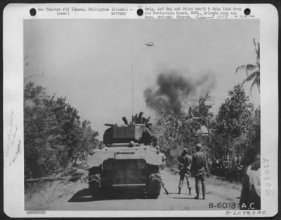 Consolidated > Bombs Away Over Batangas Province, Luzon, Philippine Islands.  Two 300-Lb. Bombs, Visible Under The Fuselage Of A P-39, Are Headed For Japanese Installations Only 75 Yards In Front Of U.S. Infantry Advance.  Explosion In The Background Is From Artillery S