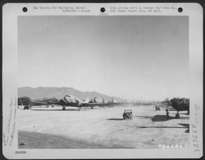 Consolidated > Douglas C-47s lined up for the morning take-off on the parking strip near the tower on the North Strip at Myitkyina, Burma. 16 December 1944.