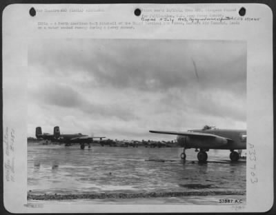 Consolidated > INDIA-A North American B-25 Mitchell of the Third Tactical Air Force, Eastern Air Command, lands on a water soaked runway during a heavy shower.