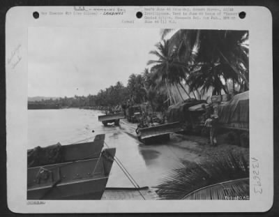 Consolidated > Landing at Hollandia in Humboldt Bay, New Guinea on 22 April 44. Bulldozers roll along to repair roads and strips.