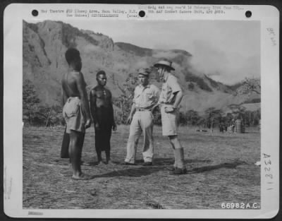 Thumbnail for Consolidated > Engineering officer confering with Angou Warrant officer in regards to native labor for work on revetments. Each worker is paid 1/2 pound a month and have been invaluable in early stages of the area. New Guinea, January 1944.