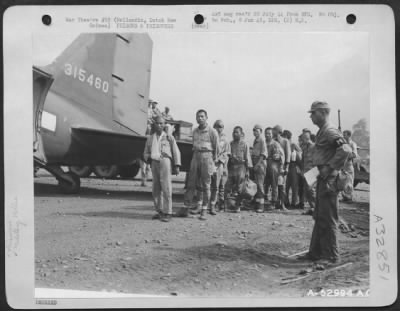 Consolidated > Japanese prisoners of war from Biak Island being loaded at Hollandia, Dutch New Guinea, for transfer to Brisbane, Australia.