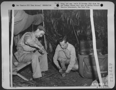 Consolidated > It's chow time for these men in the jungles of Markham Valley in New Guinea. 11 September 1943.