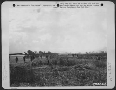 Thumbnail for Consolidated > Natives of New Guinea crowd around supply laden Douglas C-47's which have landed at Nadzab Airstrip, New Guinea. In the distance another plane comes in for a landing. 11 September 1943.